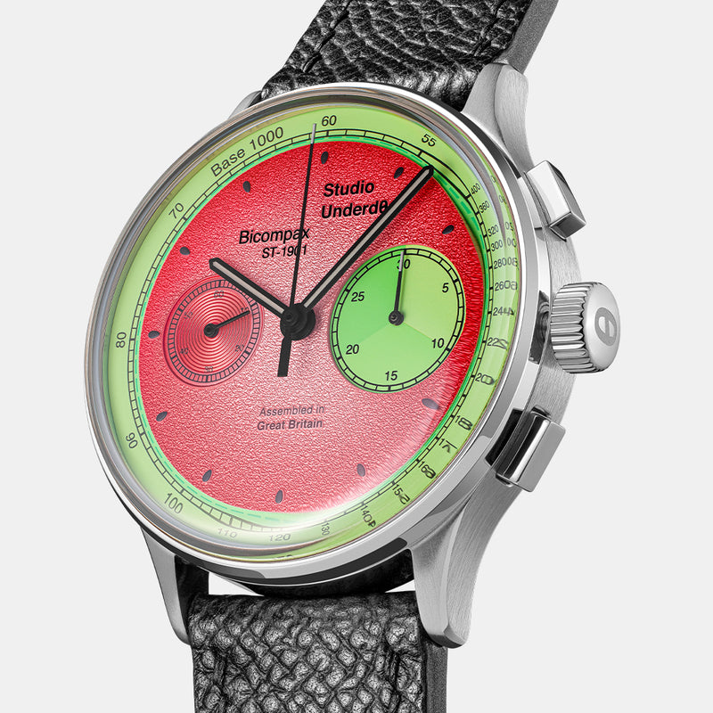 Contemporary illustrative example: an angled view highlights the textured pink dial and green chronograph register.